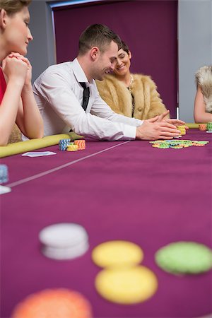 Happy people placing bets at poker game in casino Stock Photo - Budget Royalty-Free & Subscription, Code: 400-06801891