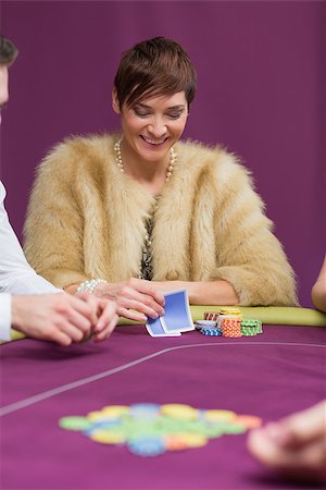 Woman smiling looking at her cards at the casino Stock Photo - Budget Royalty-Free & Subscription, Code: 400-06801892
