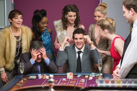 people sitting in casino - Man winning as another is losing at roulette table in casino Stock Photo - Budget Royalty-Free & Subscription, Code: 400-06801917
