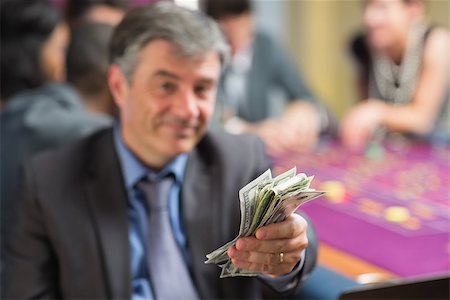 Man holding out money at roullette table in casino Stock Photo - Budget Royalty-Free & Subscription, Code: 400-06801929