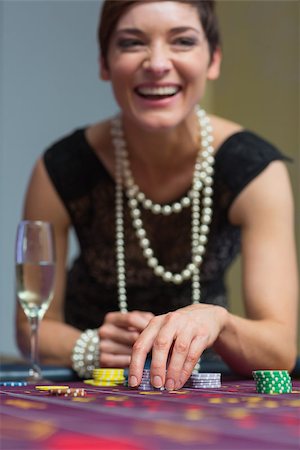 Woman laughing while sitting at table in casino Stock Photo - Budget Royalty-Free & Subscription, Code: 400-06801933