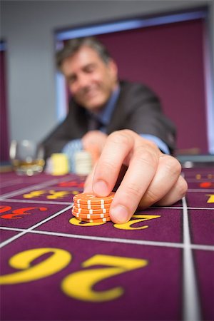 simsearch:400-06802091,k - Man placing roulette bet in casino Stock Photo - Budget Royalty-Free & Subscription, Code: 400-06801965