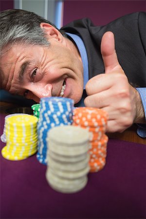 simsearch:400-06802091,k - Man leaning on roulette table and giving thumbs up in casino Stock Photo - Budget Royalty-Free & Subscription, Code: 400-06801969