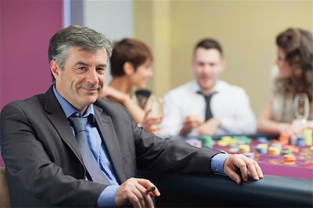 simsearch:400-06802091,k - Man with cigar taking break from roulette table in casino Stock Photo - Budget Royalty-Free & Subscription, Code: 400-06801993