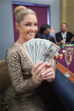 simsearch:400-06802091,k - Blonde fanning dollars at roulette table in casino Stock Photo - Budget Royalty-Free & Subscription, Code: 400-06802007