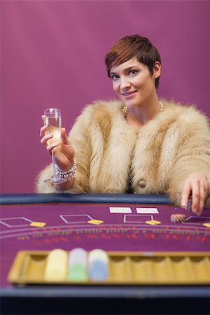 Woman sitting in a casino at table while drinking champagne and stacking chips Stock Photo - Budget Royalty-Free & Subscription, Code: 400-06802024