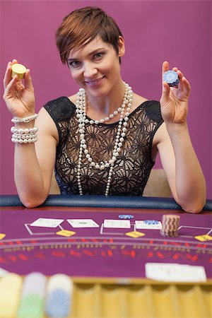 Woman sitting in a casino at table with chips in her hand Stock Photo - Budget Royalty-Free & Subscription, Code: 400-06802029