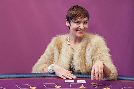 Woman sitting in a casino at table while stacking chips and placing cards Stock Photo - Budget Royalty-Free & Subscription, Code: 400-06802022