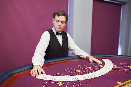 Dealer spreading deck of cards in casino at poker table Stock Photo - Budget Royalty-Free & Subscription, Code: 400-06802066