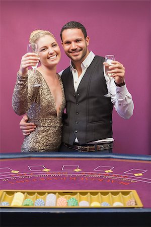 Two people standing at table in a casino while amusing and toasting Foto de stock - Super Valor sin royalties y Suscripción, Código: 400-06802083