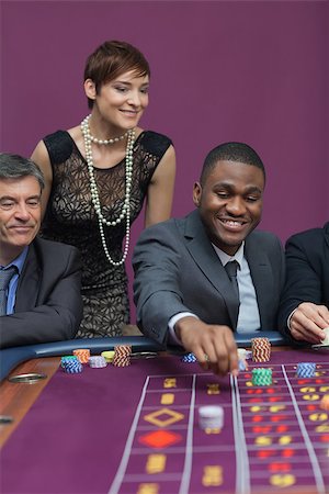 simsearch:400-06802094,k - Bets being placed at roulette table in casino Foto de stock - Super Valor sin royalties y Suscripción, Código: 400-06802097