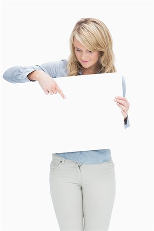 Woman pointing on the piece of paper while holding it Stock Photo - Budget Royalty-Free & Subscription, Code: 400-06802244