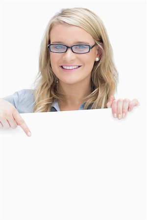 Woman wearing glasses and pointing on the paper while holding it Stock Photo - Budget Royalty-Free & Subscription, Code: 400-06802249