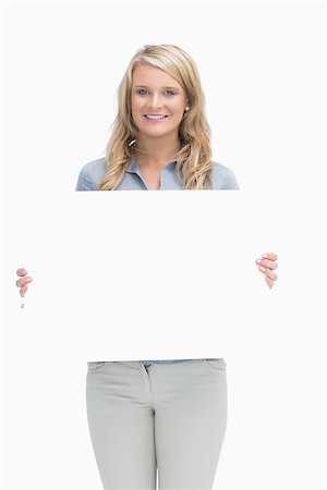 Blonde woman holding a large white poster Stock Photo - Budget Royalty-Free & Subscription, Code: 400-06802242