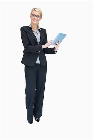 simsearch:400-06802290,k - Smiling businesswoman standing while holding and using tablet pc Stock Photo - Budget Royalty-Free & Subscription, Code: 400-06802290