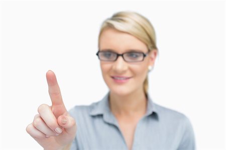 simsearch:400-06802290,k - Businesswoman wearing glasses and presenting something while showing on it with a finger Stock Photo - Budget Royalty-Free & Subscription, Code: 400-06802324