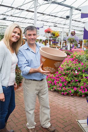 Happy couple holding ceramic flower pot in garden center Stock Photo - Budget Royalty-Free & Subscription, Code: 400-06802604