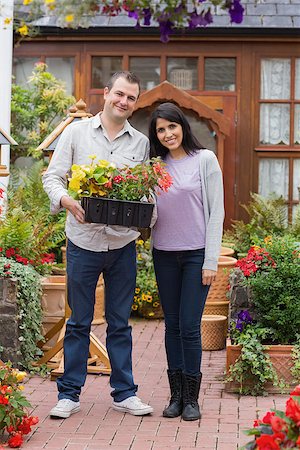 Smiling couple holding tray of plants in the garden center Stock Photo - Budget Royalty-Free & Subscription, Code: 400-06802799