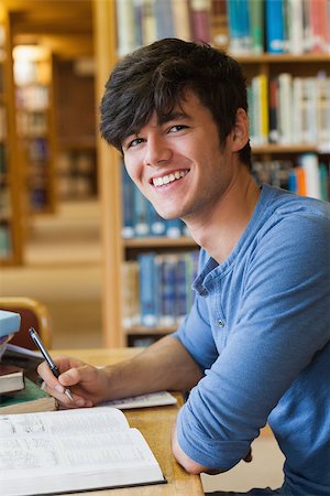 simsearch:400-06803206,k - Student sitting at the library smiling Stock Photo - Budget Royalty-Free & Subscription, Code: 400-06802919