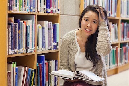 Woman getting stressed on sitting on library floor Stock Photo - Budget Royalty-Free & Subscription, Code: 400-06803024