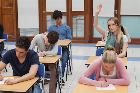 Woman raising hand during exam in exam hall in college Stock Photo - Budget Royalty-Free & Subscription, Code: 400-06803068