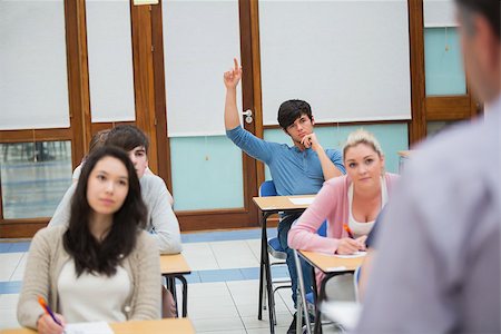 Student raising hand to ask question in college classroom Stock Photo - Budget Royalty-Free & Subscription, Code: 400-06803106