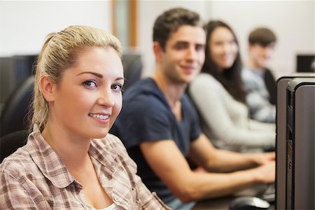 simsearch:400-07267978,k - Students sitting at the computer room smiling Stock Photo - Budget Royalty-Free & Subscription, Code: 400-06803130