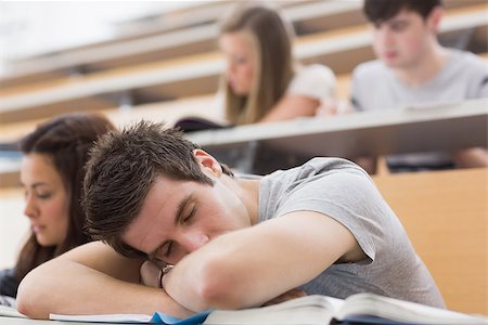 simsearch:400-06803206,k - Student sitting at the lecture hall leaning on the table sleeping Stock Photo - Budget Royalty-Free & Subscription, Code: 400-06803185