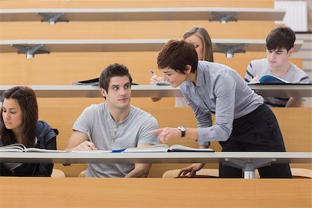 simsearch:400-06803206,k - Teacher helping student at the lecture hall Stock Photo - Budget Royalty-Free & Subscription, Code: 400-06803196