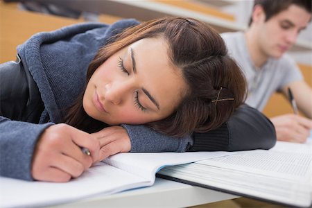 simsearch:400-06803206,k - Woman leaning at the desk at the lecture hall dozing Stock Photo - Budget Royalty-Free & Subscription, Code: 400-06803193