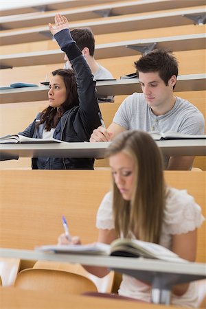 simsearch:400-06803206,k - Student sitting at the lecture hall with hand up to ask question Stock Photo - Budget Royalty-Free & Subscription, Code: 400-06803204