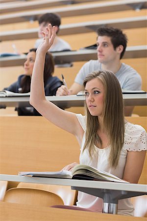 simsearch:400-06803206,k - Woman sitting at the lecture hall with hand up to ask question Stock Photo - Budget Royalty-Free & Subscription, Code: 400-06803205