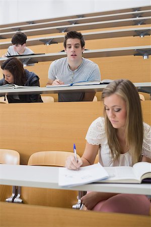 simsearch:400-06803206,k - Student looking at another students work sneakily in lecture hall Stock Photo - Budget Royalty-Free & Subscription, Code: 400-06803203