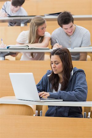 simsearch:400-06803206,k - Student using laptop to take notes in lecture hall Stock Photo - Budget Royalty-Free & Subscription, Code: 400-06803213