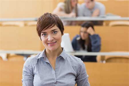 simsearch:400-06803206,k - Woman standing at the lecture hall while smiling Stock Photo - Budget Royalty-Free & Subscription, Code: 400-06803227