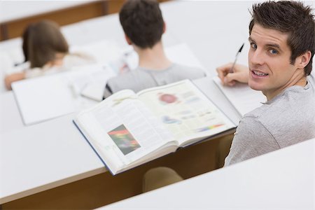 simsearch:400-06803206,k - Man sitting at the lecture hall writing and making notes Stock Photo - Budget Royalty-Free & Subscription, Code: 400-06803245