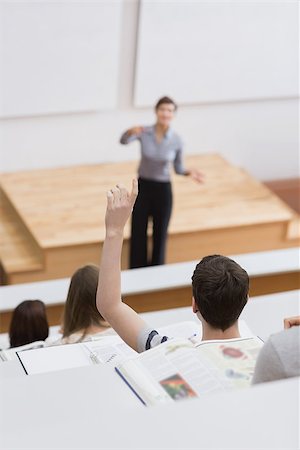 simsearch:400-06803206,k - Teacher standing explaining while student hands up Stock Photo - Budget Royalty-Free & Subscription, Code: 400-06803248