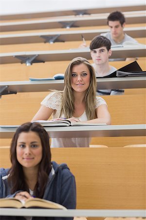 simsearch:400-06803206,k - Students sitting while smiling in lecture hall in different rows Stock Photo - Budget Royalty-Free & Subscription, Code: 400-06803243