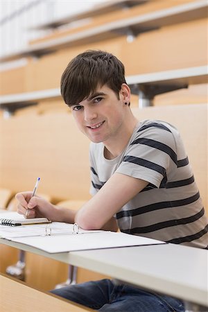 simsearch:400-06803206,k - Man sitting at the lecture hall while smiling and making notes Stock Photo - Budget Royalty-Free & Subscription, Code: 400-06803254