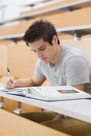 simsearch:400-06803206,k - Man sitting at the lecture hall while writing Stock Photo - Budget Royalty-Free & Subscription, Code: 400-06803252