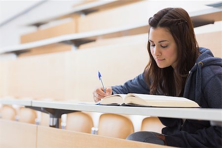 simsearch:400-06803206,k - Girl reading a book and writing notes at the lecture hall Stock Photo - Budget Royalty-Free & Subscription, Code: 400-06803264