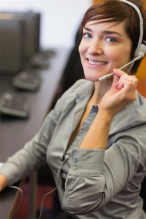 simsearch:400-07267978,k - Teacher sitting at the computer room while wearing a headset in college Stock Photo - Budget Royalty-Free & Subscription, Code: 400-06803279