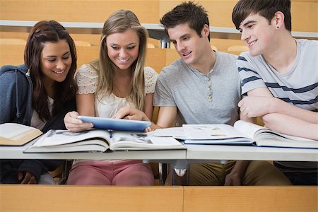 simsearch:400-06803206,k - Students sitting at the lecture hall looking at tablet pc while smiling Stock Photo - Budget Royalty-Free & Subscription, Code: 400-06803271