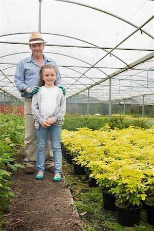 Gardener with granddaughter standing and smiling in greenhouse Stock Photo - Budget Royalty-Free & Subscription, Code: 400-06803372