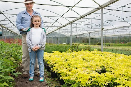 Little girl with grandfather standing and smiling in greenhouse Stock Photo - Budget Royalty-Free & Subscription, Code: 400-06803373