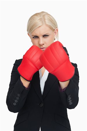 simsearch:400-06876600,k - Serious businesswoman wearing red boxing gloves against white background Stock Photo - Budget Royalty-Free & Subscription, Code: 400-06803445
