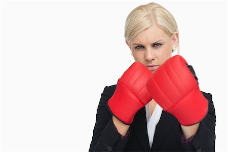 simsearch:400-06876600,k - Serious blonde in suit wearing red gloves against white background Stock Photo - Budget Royalty-Free & Subscription, Code: 400-06803446