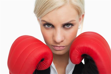 simsearch:400-06876600,k - Serious green eyed woman with red gloves fighting against white background Stock Photo - Budget Royalty-Free & Subscription, Code: 400-06803455