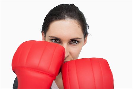 simsearch:400-06876600,k - Serious brunette woman wearing red gloves against white background Stock Photo - Budget Royalty-Free & Subscription, Code: 400-06803458