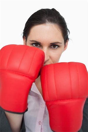 simsearch:400-06876600,k - Serious brunette wearing red gloves against white background Stock Photo - Budget Royalty-Free & Subscription, Code: 400-06803459